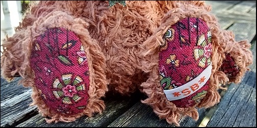 Hugo's paws with the SB label
